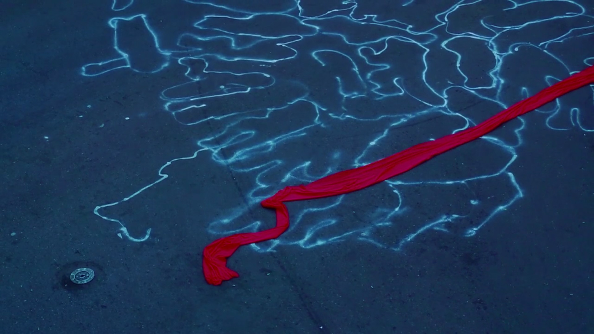 Chalk outlines on pavement with a long red scarf in a still from Blue and Red (2014) by Zhou Tao